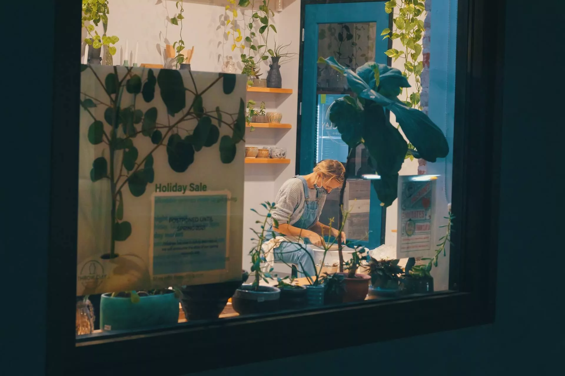 a woman working in a plant shop at night